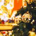 Christmas gold balls hanging on a Christmas tree on the background of blurred interior shopping center, mall.