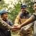 Group of hikers stacking hands
